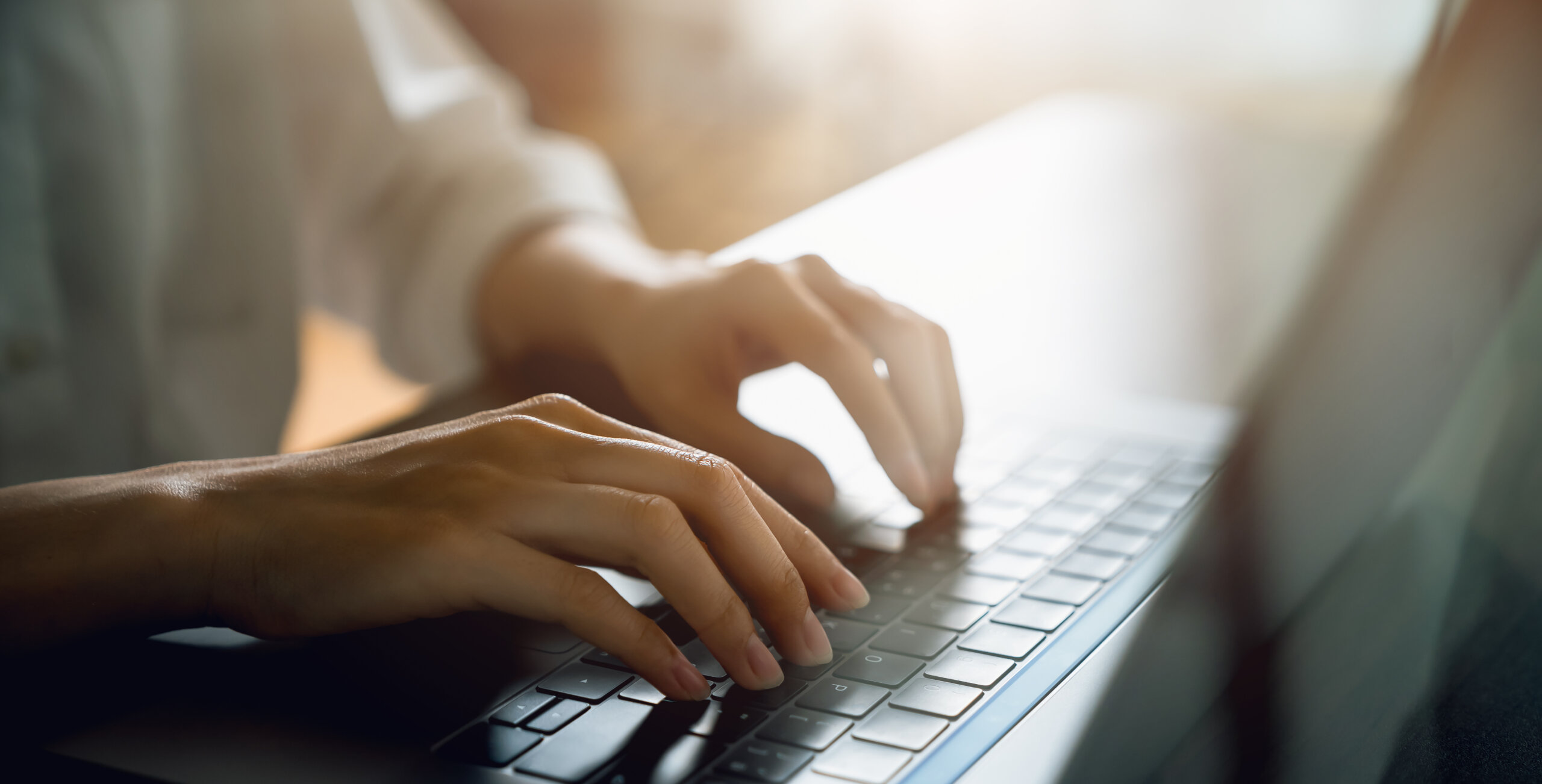 close up of hand using on keyboard laptop and typing with social media on internet.